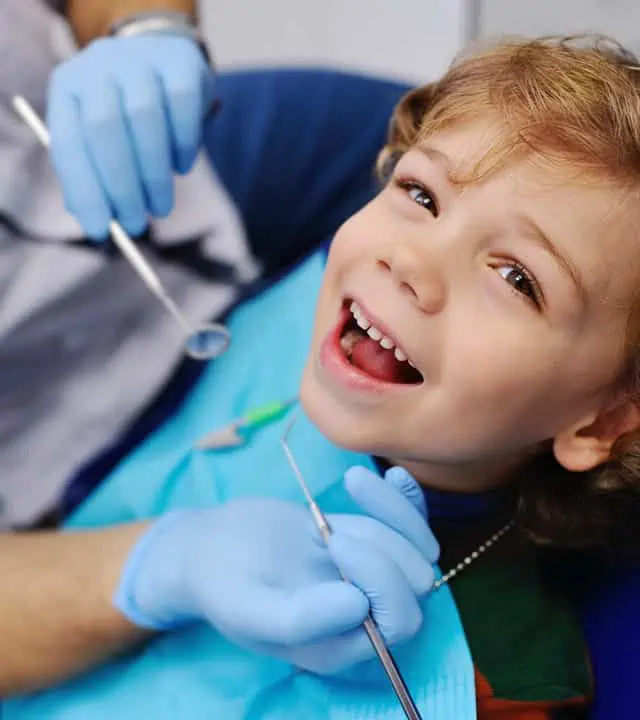 young boy in the dental office smiling before a procedure
