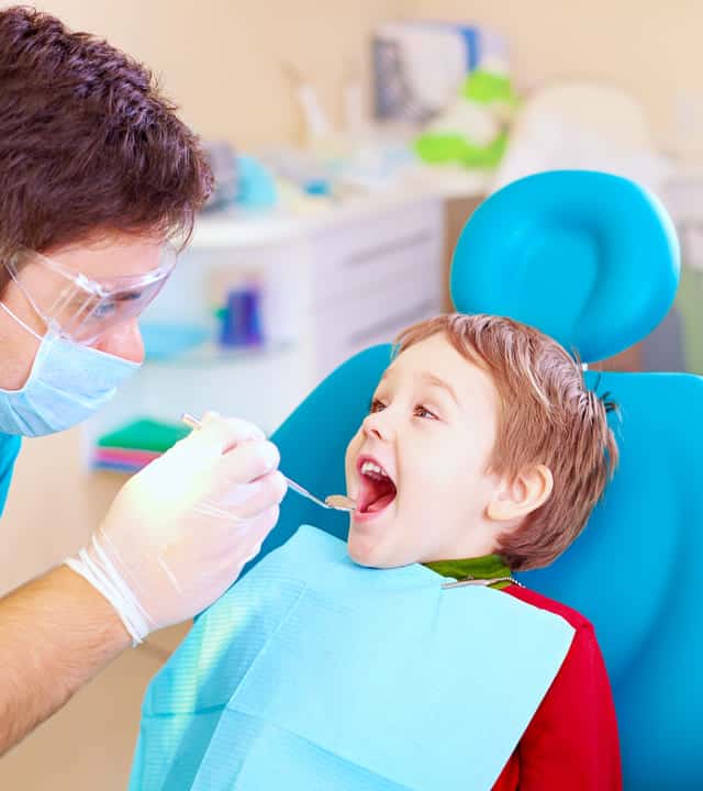 Young child opening his mouth widely for the dentist