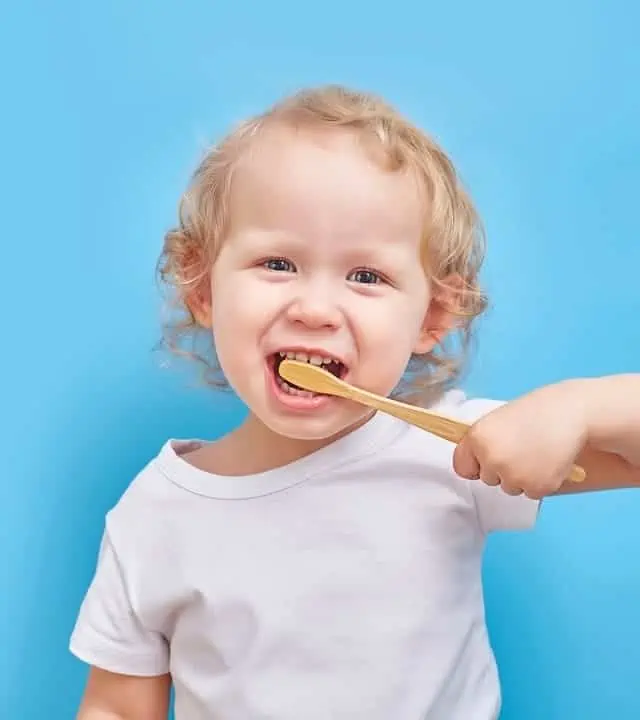 small child brushing his teeth