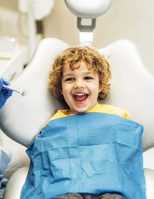 Little boy sitting in the dentist's chair smiling