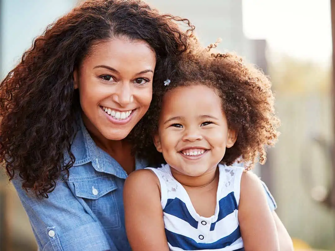 Young women with daughter smiling
