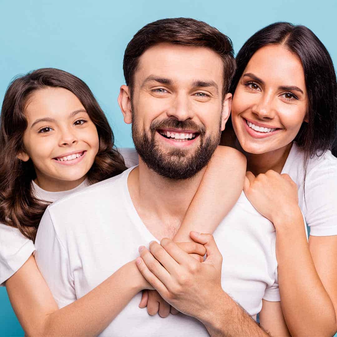 Young family holding each other and smiling